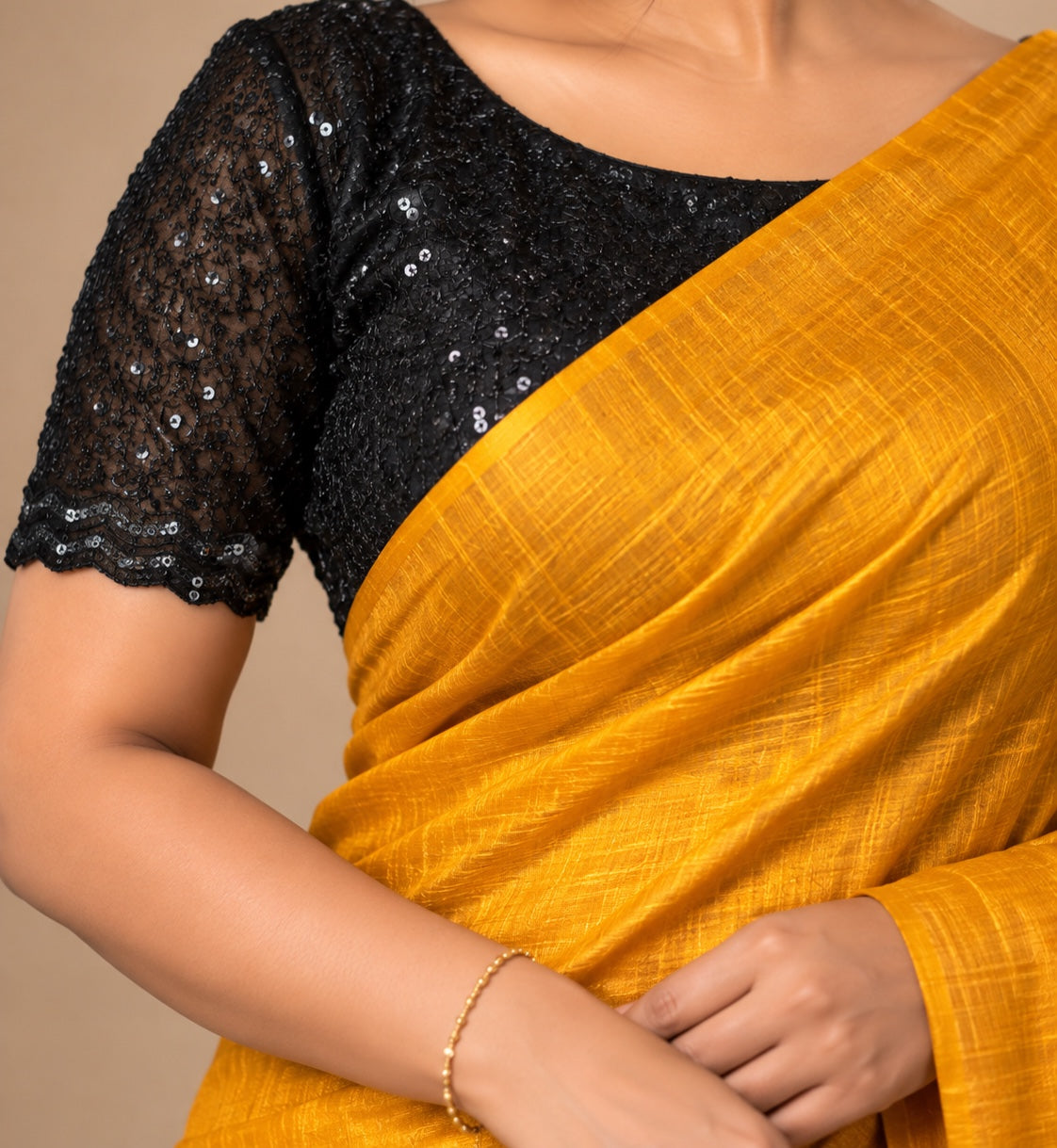 Close-up of the black sequin-embellished lace blouse against the mustard yellow Vichitra saree, PS01